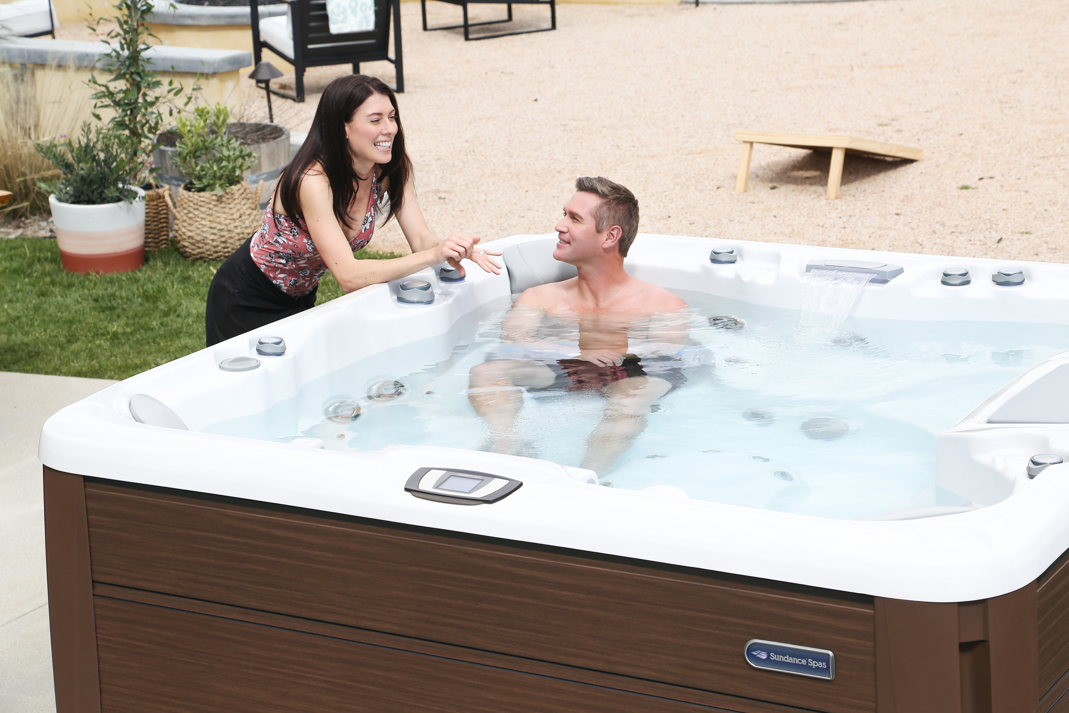 Man talking to woman while soaking in the hot tub